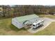 Aerial angle of metal outbuilding with green roof, RV and covered entrance area at 4194 Abattoir Rd, Angier, NC 27501