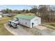 Exterior of large metal outbuilding with green roof and RV parked nearby at 4194 Abattoir Rd, Angier, NC 27501