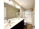 Clean bathroom with double sinks, a large mirror, and a walk-in shower, creating a functional space at 4519 Tarkiln Pl, Wake Forest, NC 27587
