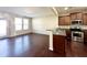Bright and open kitchen area with stainless appliances, granite counters, and hardwood flooring at 4519 Tarkiln Pl, Wake Forest, NC 27587