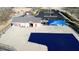 Aerial view of a community pool with blue coverings, set next to a parking lot and changing facilities at 4519 Tarkiln Pl, Wake Forest, NC 27587