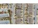 Aerial view of townhouses with street and car lined driveways at 556 Village Loop Dr, Apex, NC 27502