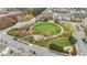 Aerial view of a common green space surrounded by flower beds, walkways, and a couple benches at 556 Village Loop Dr, Apex, NC 27502