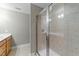 Bathroom with a light wood vanity and a tiled walk-in shower at 556 Village Loop Dr, Apex, NC 27502