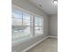 Well-lit room with large windows and neutral carpet, offering a bright and clean space at 556 Village Loop Dr, Apex, NC 27502