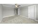 Open and airy bedroom with neutral paint, white trim, a ceiling fan, and carpet at 556 Village Loop Dr, Apex, NC 27502