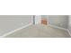 Bedroom with neutral carpet and trim, plus a view into another room via an open door at 556 Village Loop Dr, Apex, NC 27502