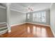 Light and bright bedroom featuring hardwood floors, neutral color, ceiling fan, and large windows at 556 Village Loop Dr, Apex, NC 27502