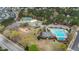 Aerial view of various community amenities with swimming pool, clubhouse, playground and tennis courts for all residents at 556 Village Loop Dr, Apex, NC 27502