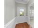 Bright entryway with wood floors, wainscoting, and a view of the sunny neighborhood at 556 Village Loop Dr, Apex, NC 27502