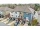 Exterior elevation of townhomes with back decks, cars and driveways at 556 Village Loop Dr, Apex, NC 27502