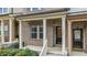 Close-up view of a front porch showcasing its design with brick pillars and detailed entry door at 556 Village Loop Dr, Apex, NC 27502