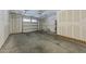 Spacious unfinished garage with roll up doors and concrete floor at 556 Village Loop Dr, Apex, NC 27502