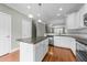 Modern kitchen with white cabinetry, an island, and stainless steel appliances at 556 Village Loop Dr, Apex, NC 27502