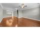 Open floor plan living area with hardwood floors, recessed lighting, and staircase to the second floor at 556 Village Loop Dr, Apex, NC 27502