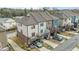 Rear view of townhomes featuring private balconies, driveways and garage parking at 556 Village Loop Dr, Apex, NC 27502