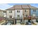 Charming townhome exterior with a private deck and garage, offering a blend of comfort and convenience at 556 Village Loop Dr, Apex, NC 27502