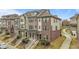 Street view of townhomes featuring brick and siding exteriors with manicured lawns at 556 Village Loop Dr, Apex, NC 27502