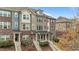 Brick and siding townhomes present an attractive facade with well-maintained landscaping at 556 Village Loop Dr, Apex, NC 27502
