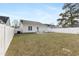 View of the home's backyard with a white fence and newly installed generator at 600 Cuddington Ln, Nashville, NC 27856
