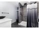 Modern bathroom featuring a stylish shower with dark tile and updated fixtures at 600 Cuddington Ln, Nashville, NC 27856