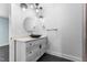 Bathroom featuring a unique vessel sink, modern lighting, and white cabinets at 600 Cuddington Ln, Nashville, NC 27856