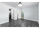 Spacious bedroom with modern gray walls, wood floors, white trim, an ensuite bathroom and a closet at 600 Cuddington Ln, Nashville, NC 27856
