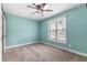 Bedroom with neutral carpet flooring, a ceiling fan, and window with blinds at 600 Cuddington Ln, Nashville, NC 27856
