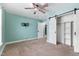 Bedroom showcasing blue walls, carpet flooring, and large sliding closet doors at 600 Cuddington Ln, Nashville, NC 27856
