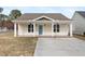 Charming single-story home featuring a covered front porch and a well-maintained yard with new driveway at 600 Cuddington Ln, Nashville, NC 27856