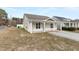 Exterior shot of a cozy home featuring a welcoming front porch, well-kept lawn, and a paved driveway at 600 Cuddington Ln, Nashville, NC 27856