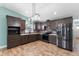 Modern kitchen boasts stainless steel appliances, stylish backsplash, ample cabinet space, and bright lighting at 600 Cuddington Ln, Nashville, NC 27856