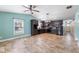 Open-concept living area with kitchen featuring stainless steel appliances, custom cabinets, and stylish lighting at 600 Cuddington Ln, Nashville, NC 27856