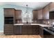Close-up of kitchen sink and countertops featuring elegant faucet, mosaic backsplash, and custom cabinets at 600 Cuddington Ln, Nashville, NC 27856