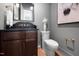 Powder room featuring wood vanity, a dark countertop, and modern fixtures at 604 Edmund St, Raleigh, NC 27604