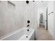 Modern tub and shower combo featuring sleek fixtures and bright tile at 604 Edmund St, Raleigh, NC 27604