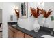 Bathroom vanity featuring natural wood cabinets, granite countertop, vessel sinks, and artistic decor at 604 Edmund St, Raleigh, NC 27604