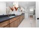 Bathroom vanity with wood cabinets, granite countertop, double sinks, and modern lighting at 604 Edmund St, Raleigh, NC 27604