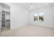 Bright bedroom with plush carpet and a doorway to a walk-in closet at 604 Edmund St, Raleigh, NC 27604