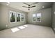Spacious bedroom with large windows letting in natural light and a ceiling fan at 604 Edmund St, Raleigh, NC 27604