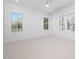 Bright bedroom with plush carpet, ceiling fan, and large windows offering natural light at 604 Edmund St, Raleigh, NC 27604