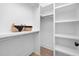 Bright walk-in closet featuring custom shelving, ample storage, and baskets at 604 Edmund St, Raleigh, NC 27604