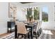 Elegant dining room with a large window, stylish chandelier, and seating for eight guests at 604 Edmund St, Raleigh, NC 27604