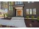 Contemporary home exterior featuring a dark gray facade, a modern door, and well-manicured landscaping at 604 Edmund St, Raleigh, NC 27604