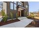 Modern home with dark exterior, large windows, and tidy front yard landscaping at 604 Edmund St, Raleigh, NC 27604