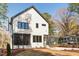 Charming two-story white home with black framed windows and a well-manicured lawn at 604 Edmund St, Raleigh, NC 27604
