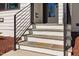 Modern front entrance with stone steps and sleek black railings and beautiful landscaping at 604 Edmund St, Raleigh, NC 27604