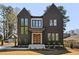 Beautiful modern home featuring a dark exterior, large windows and a striking roofline at 604 Edmund St, Raleigh, NC 27604