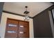 Front porch with a modern light fixture and wood front door at 604 Edmund St, Raleigh, NC 27604