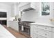 Bright kitchen featuring white cabinets, stainless steel appliances and a gas range at 604 Edmund St, Raleigh, NC 27604